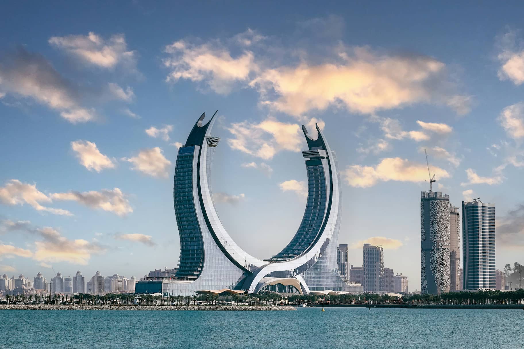 The crescent-shaped Katara Towers in Lusail, Qatar, showcasing advanced architectural design and waterfront urban development.